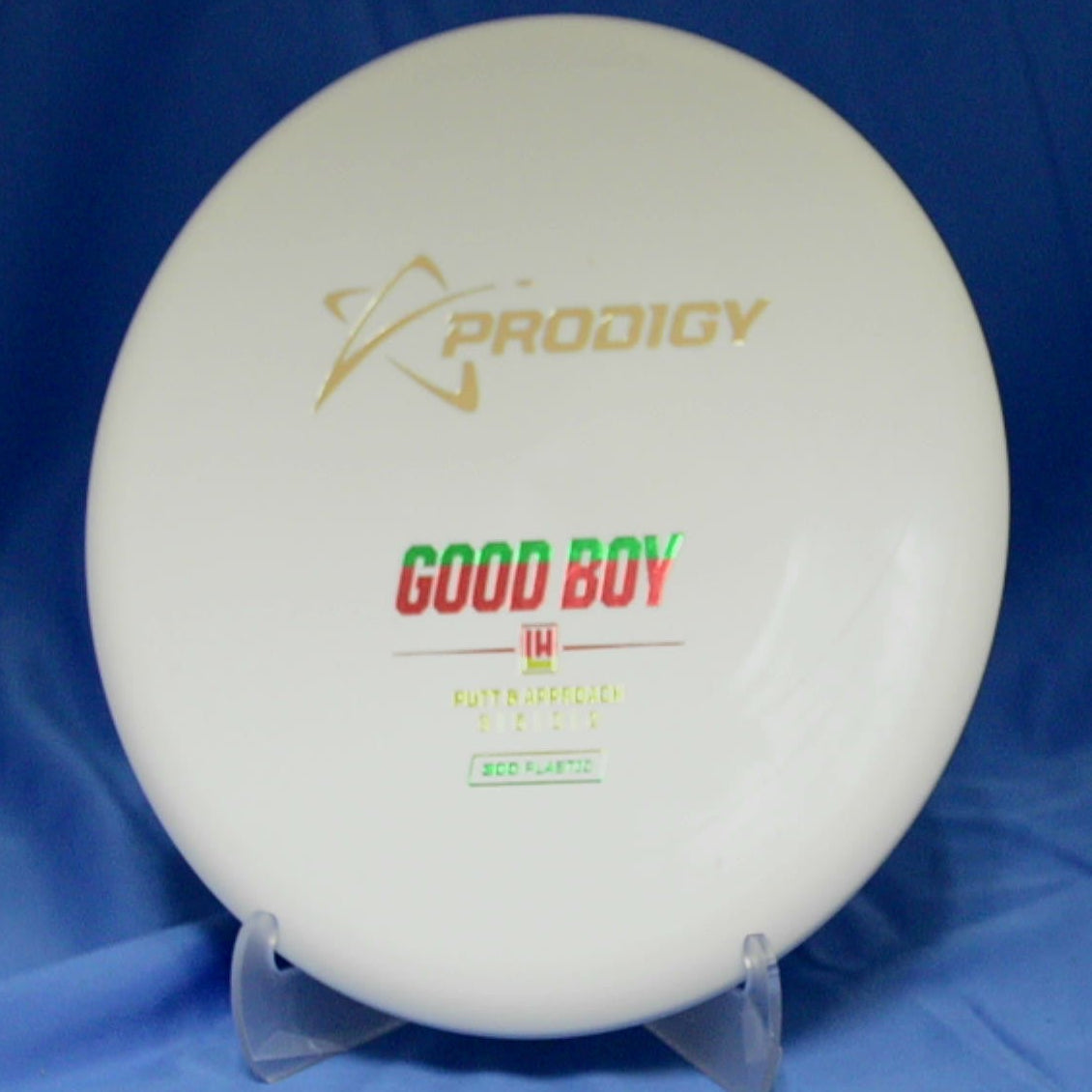 White disc golf disc with 'Prodigy' and 'Good Boy' text on a blue background